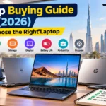 Dell, HP, ASUS and ASUS ROG laptops on a desk in Dubai with a buying checklist – laptop buying guide UAE 2026